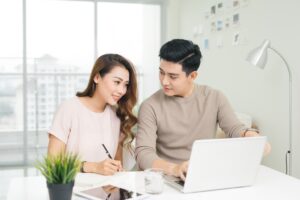 Young couple discussing ways to effectively pay off fast cash loans in Singapore