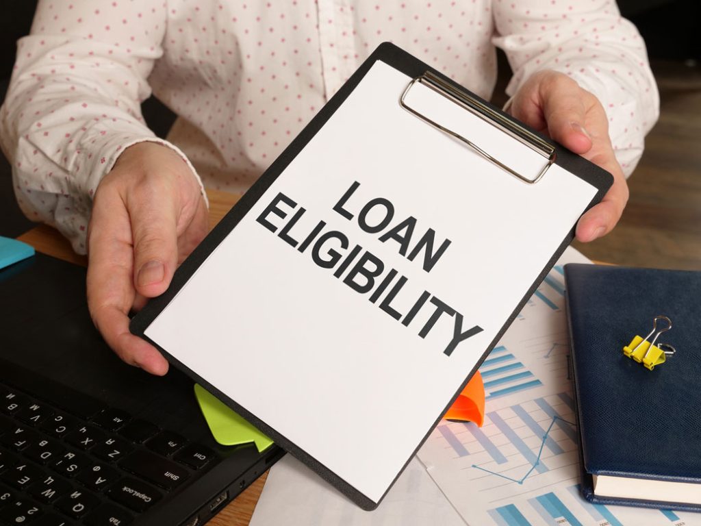 Man holding clipboard with 'Loan Eligibilty' printed on white paper for the Licensed Moneylender Singapore Review